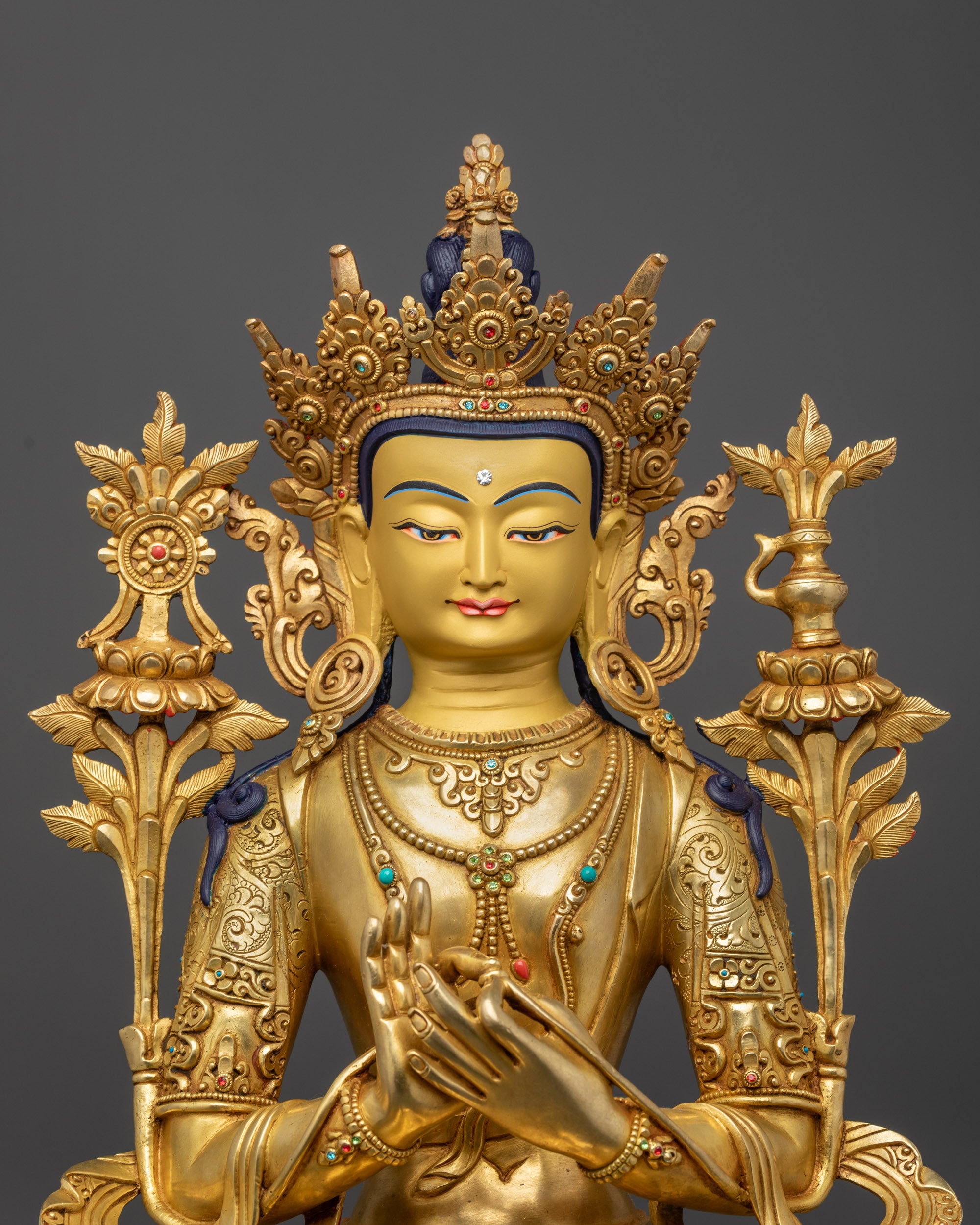 close up Maitreya Buddha Statue crown robe and dharmachakra mudra details
