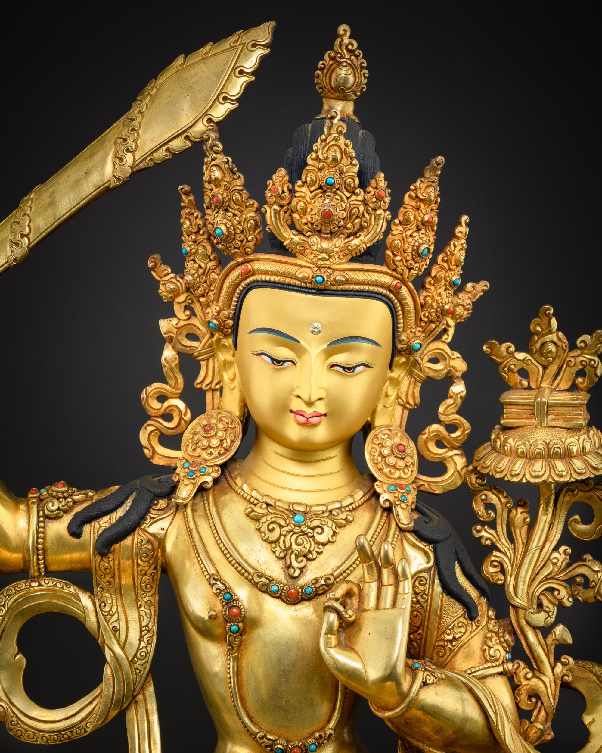 close up Manjushri Buddha statue intricate sword and scripture hand-carved by skilled Nepalese artisans