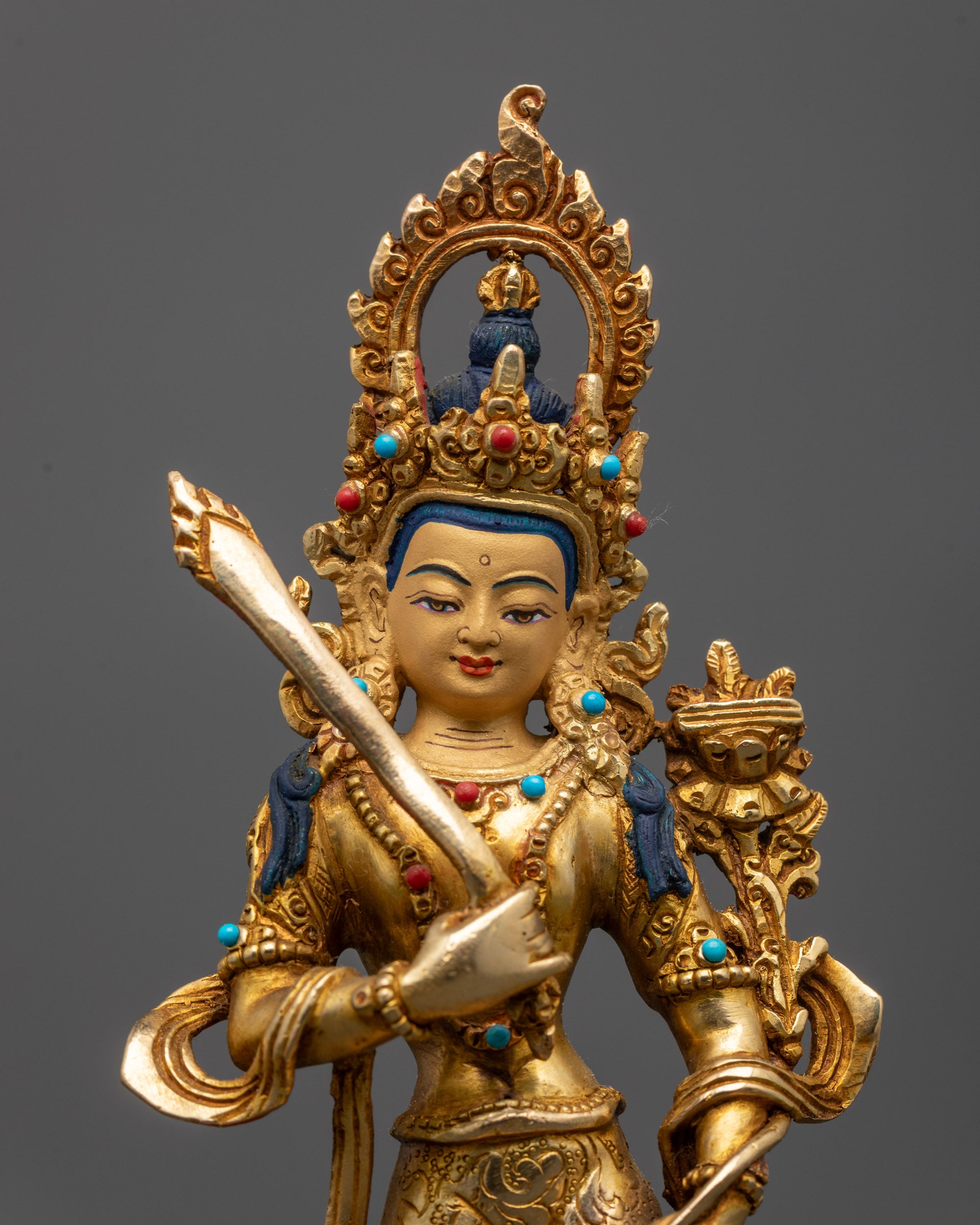 close up Manjushri face with flaming sword and Prajnaparamita Sutra details
