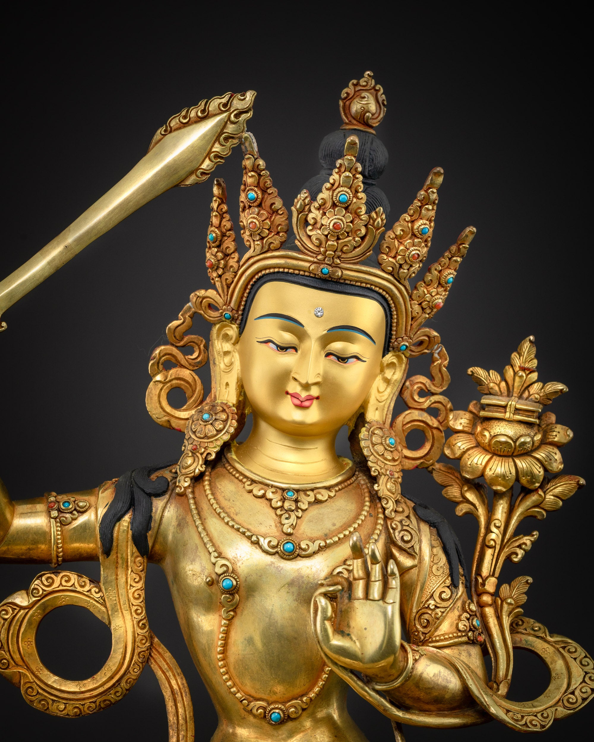 close up Manjushri statue detailed sword and compassionate hand gesture handcrafted by skilled artisans