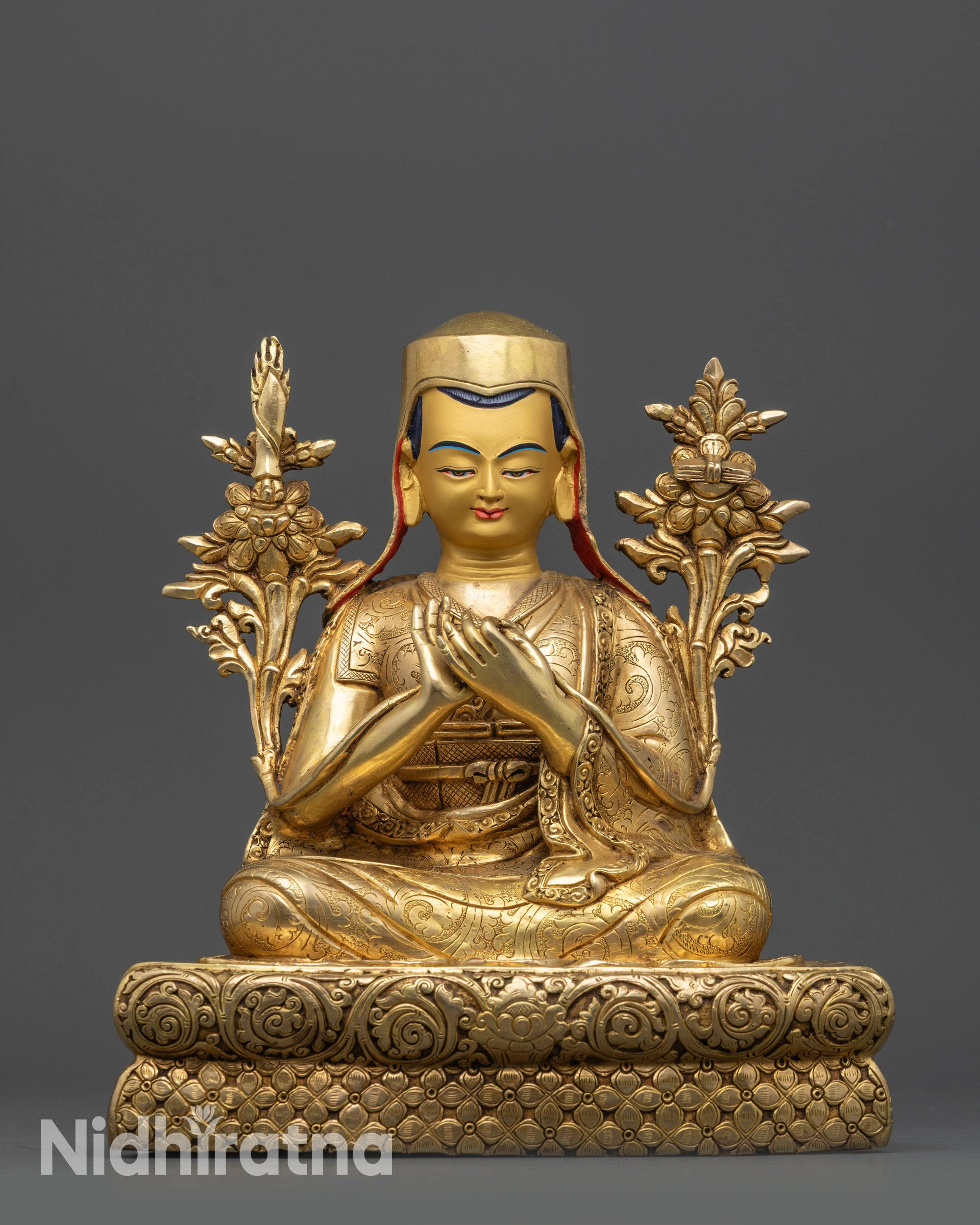 close up Sachen Kunga Nyingpo and Sakya Pandita statues gold gilded faces and robes
