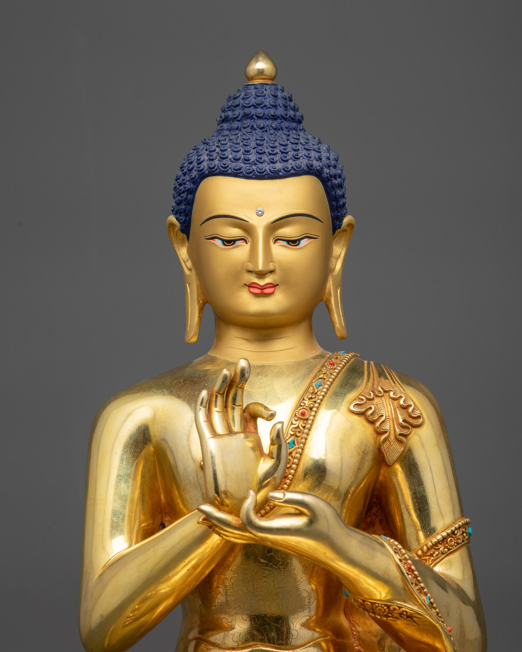 close up Suvarna Bhadra Vimala statue Dharmachakra mudra and polished lotus base
