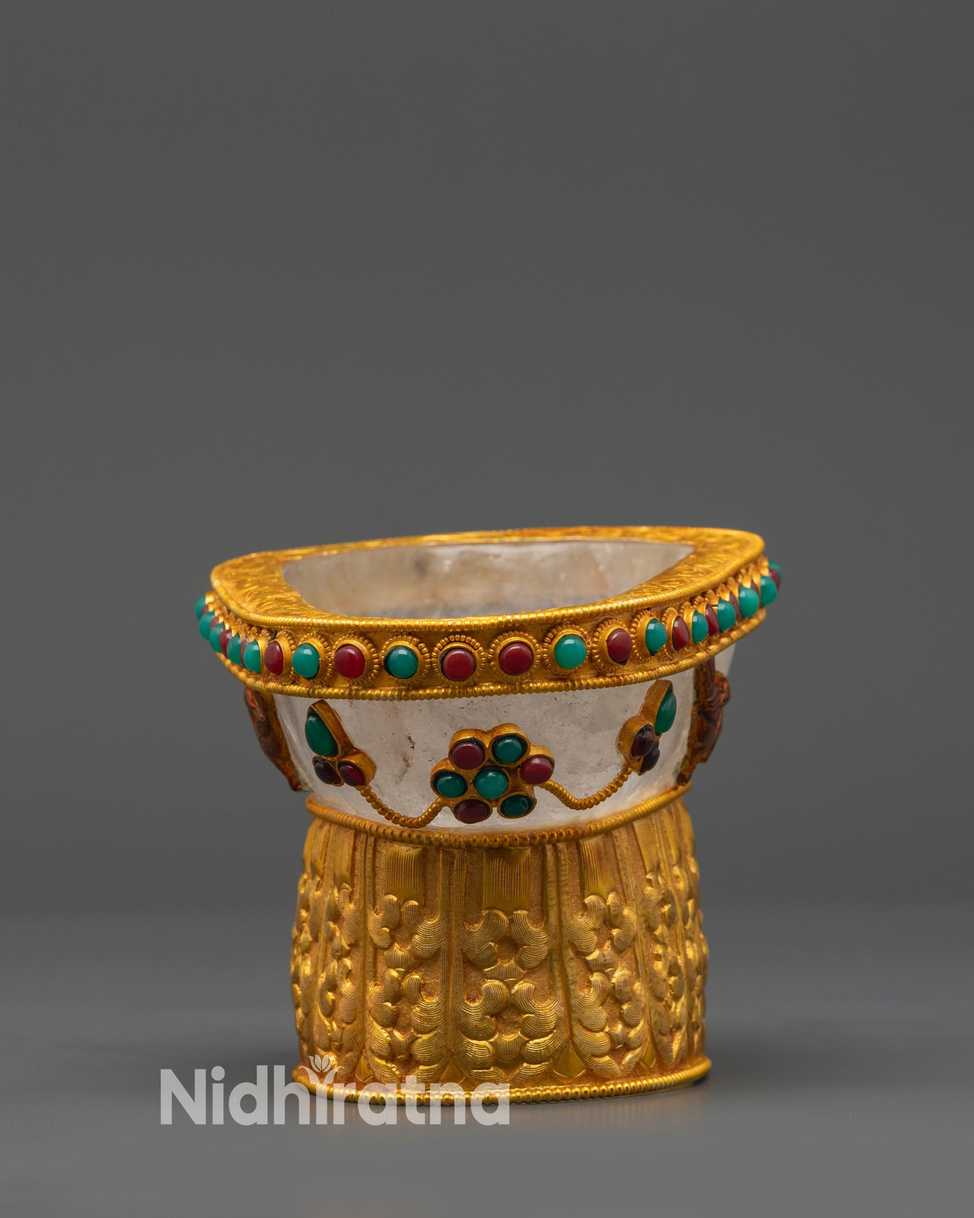 close up Tibetan Kapala showing crystal base and detailed gold-plated patterns
