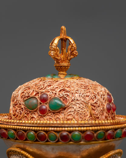 close up Tibetan Kapala skull cup with half vajra lid and semi-precious stone details

