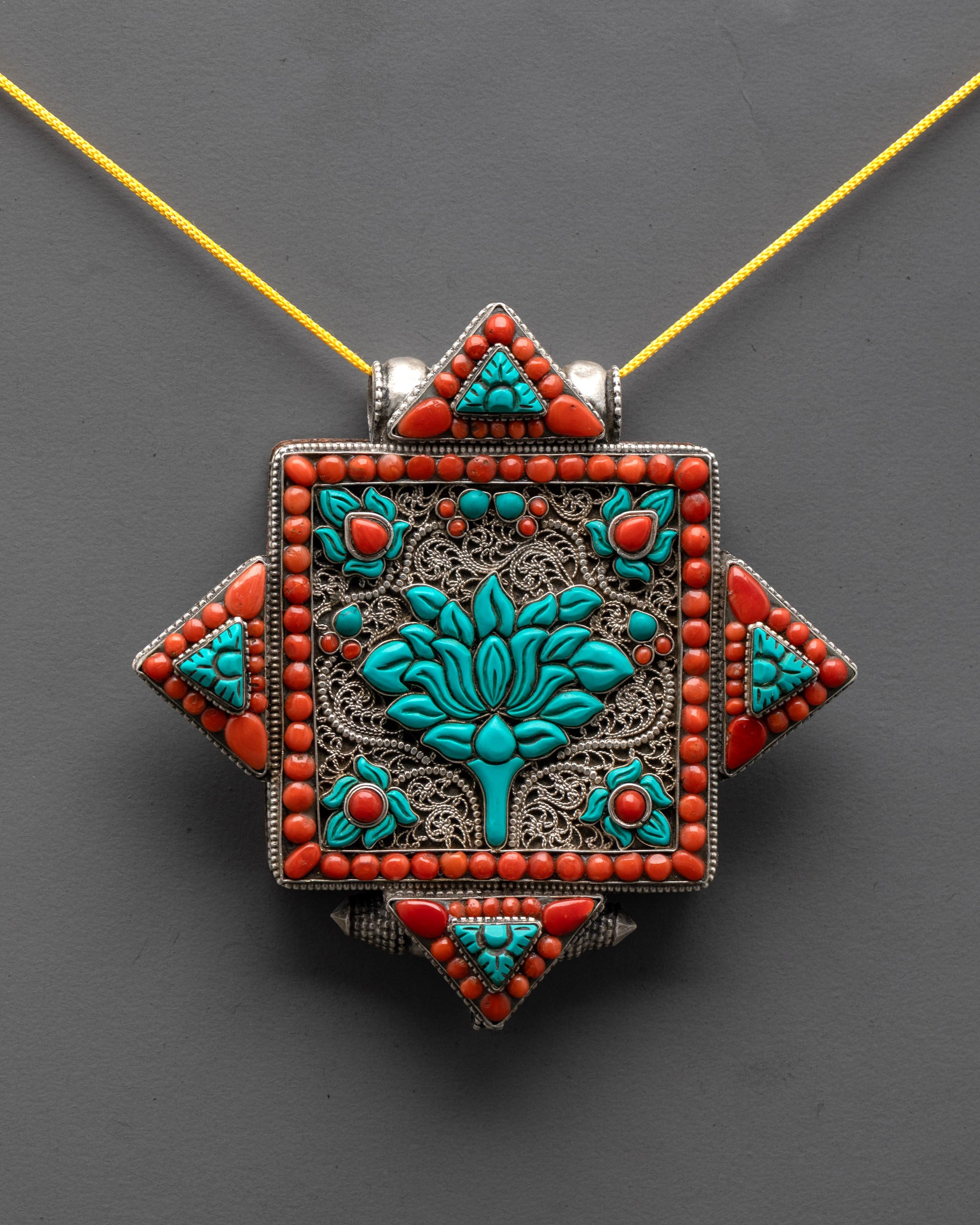 close up Tibetan lotus locket showing intricate silver filigree and sacred lotus flower symbol
