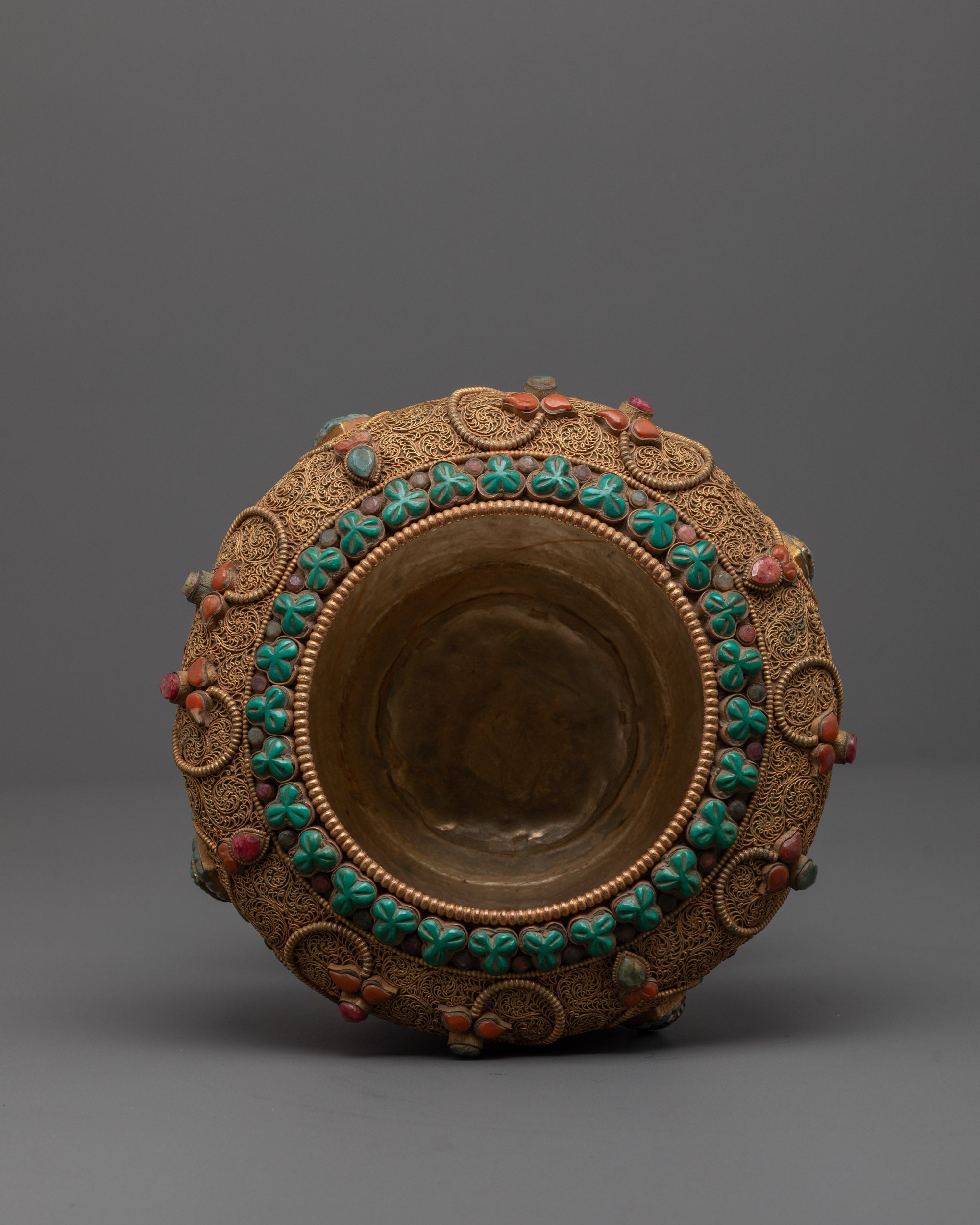close up Tibetan rice pot gold plating with intricate filigree and semi-precious stones