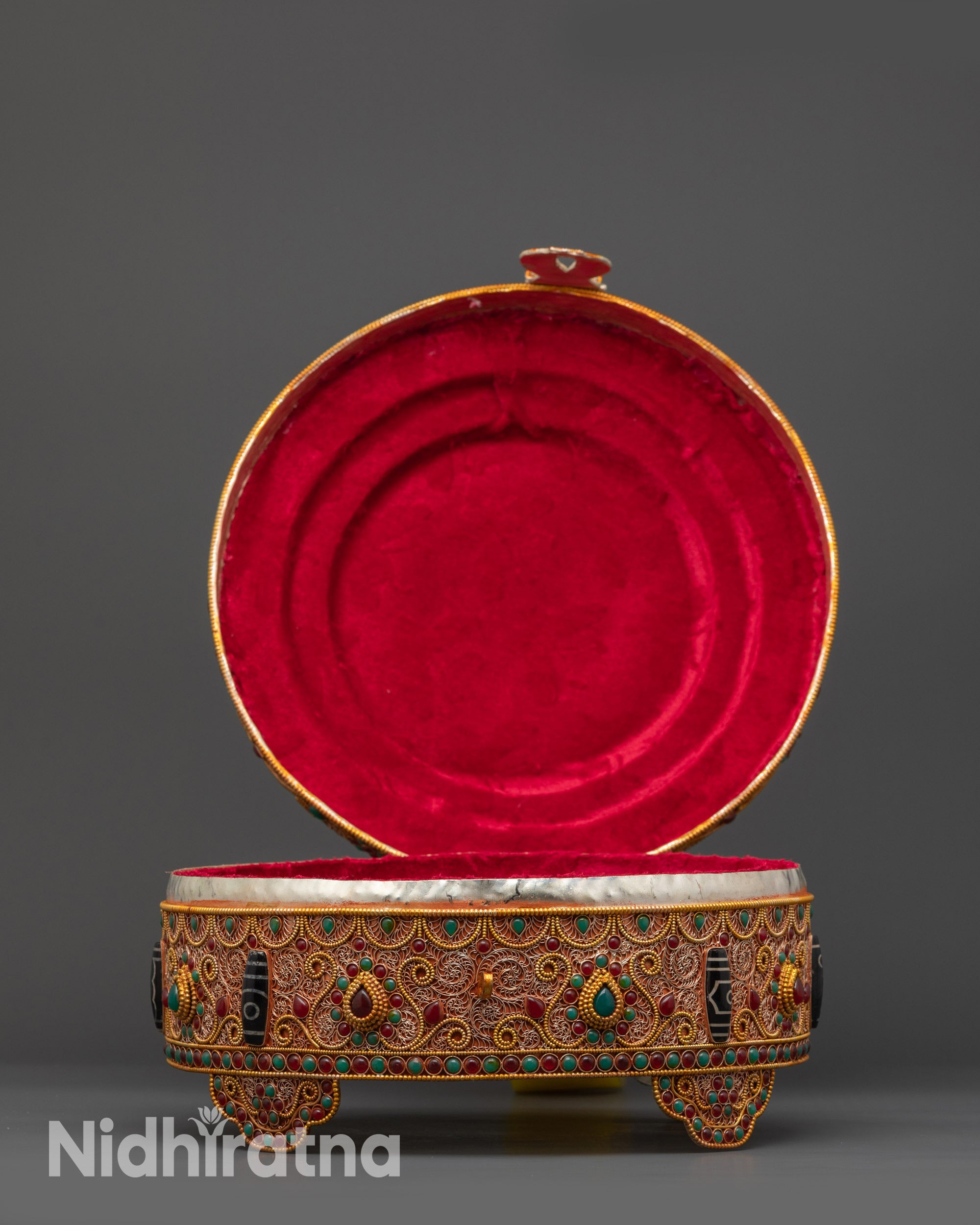 close up Tibetan ritual Treasure Box showing copper filigree and semi-precious stones
