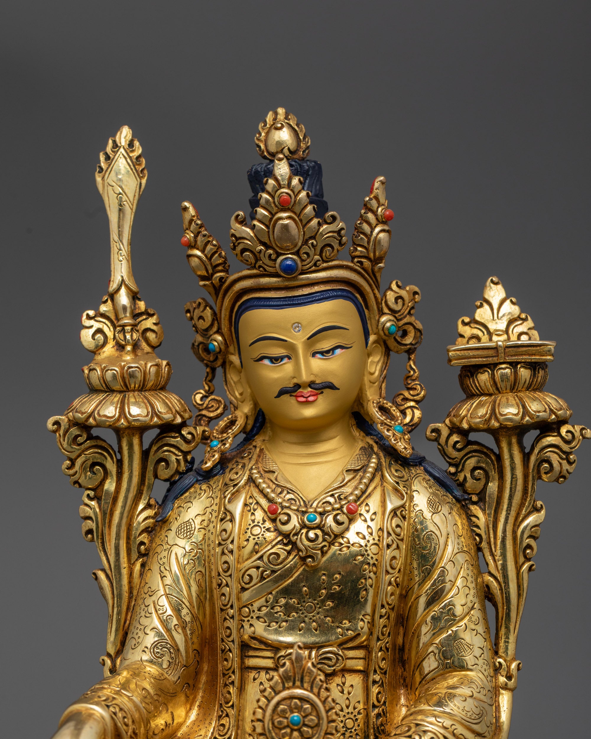 close up Trisong Detsen statue showing detailed jewelry, robe motifs, and serene expression
