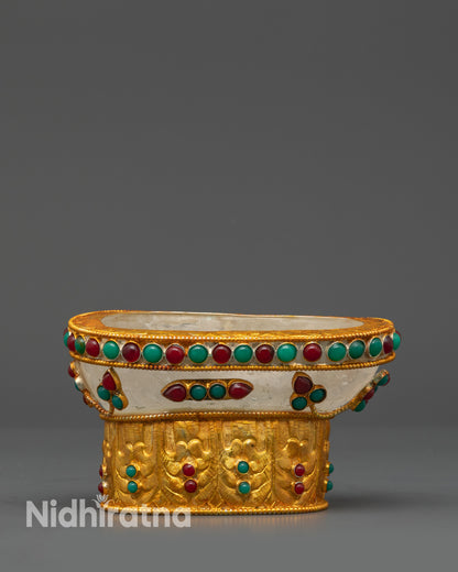 close up gold-plated ritual skull bowl showing detailed stone inlay patterns

