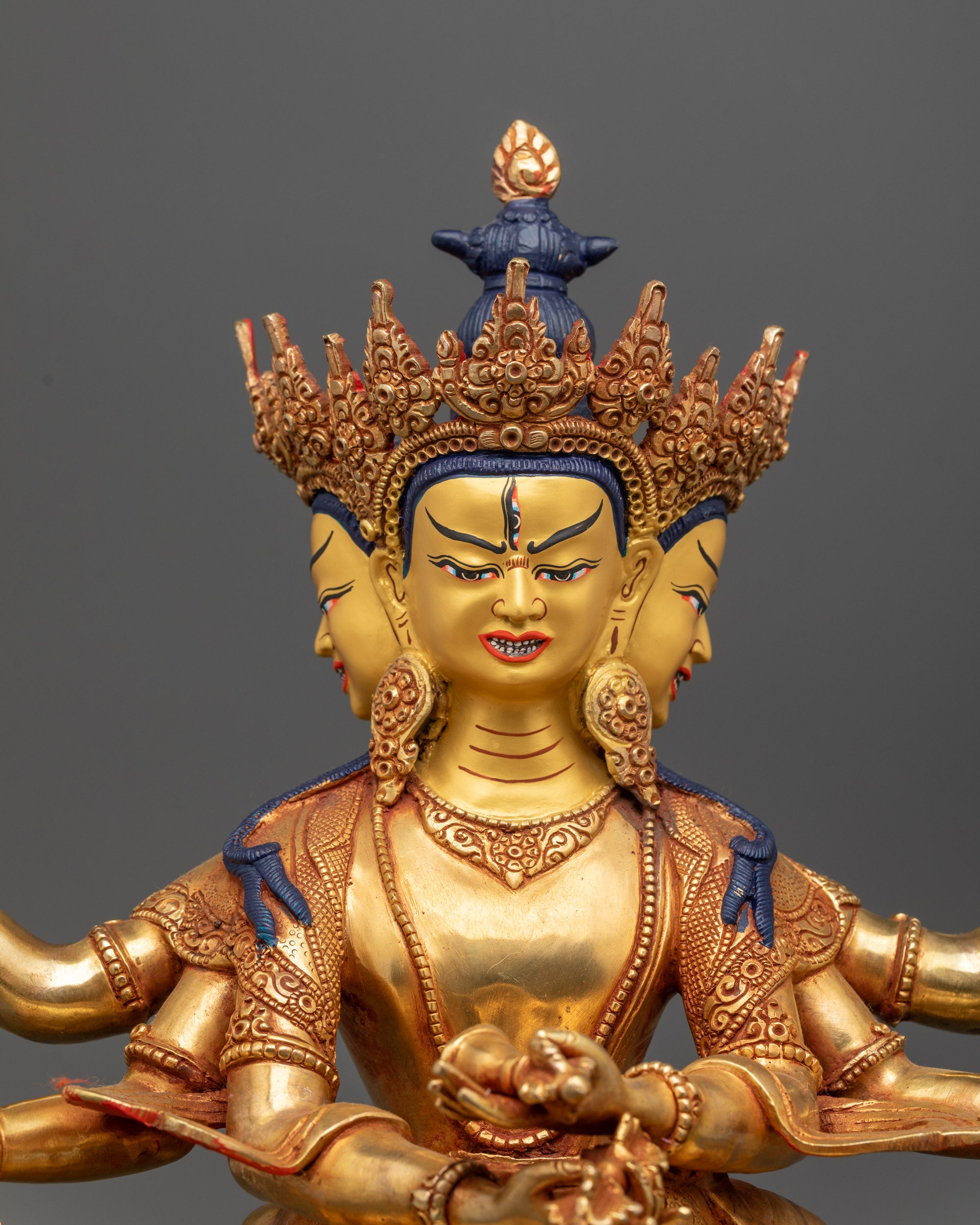 close up intricate gold face Guhyasamaja consort statue with detailed jewelry
