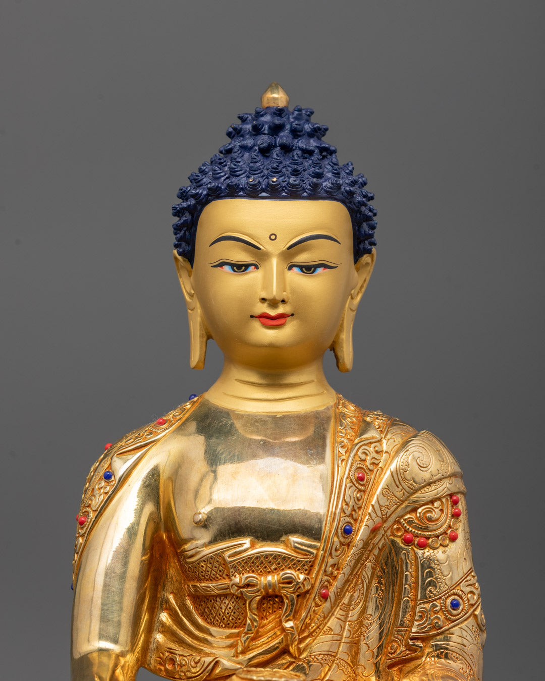 close up of 24K Gold Fire-gilded body and semi-precious stones on Shakyamuni Buddha robe