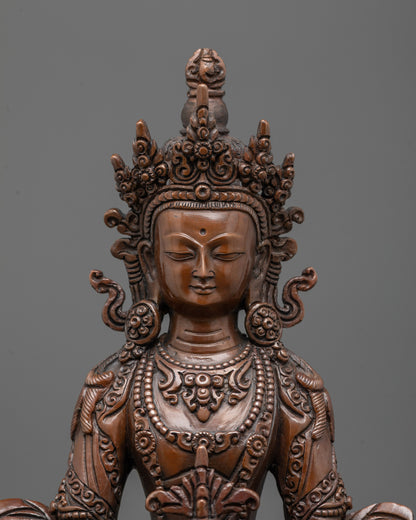 close up of Amitayus statue showing carved jewelry crown and patterned robe details