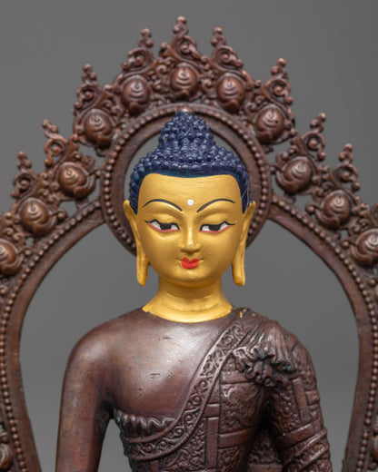 close up of Buddha Shakyamuni statue face showing gold plating and detailed monk robes pattern