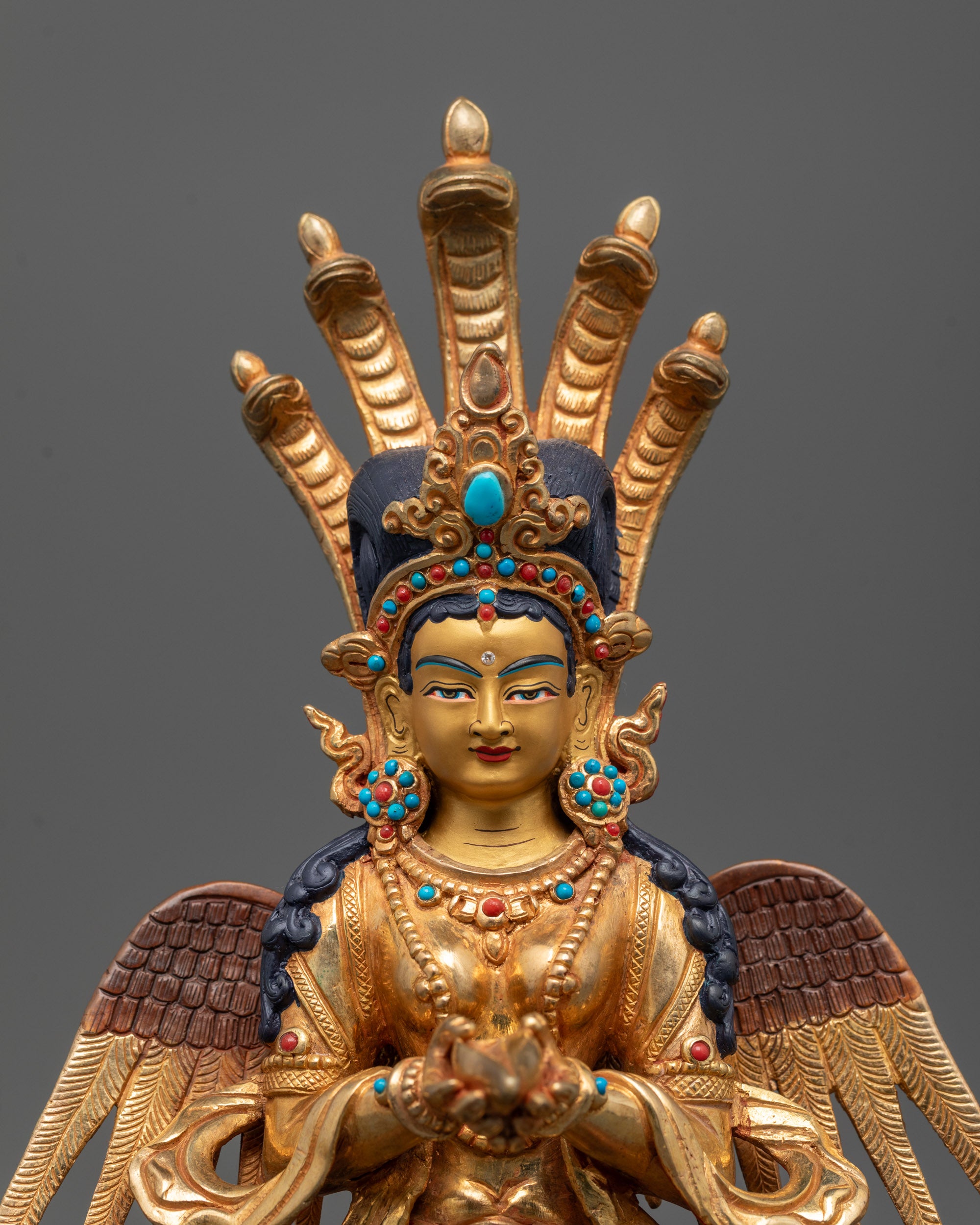 close up of Naga Kanya statue showing five serpents on head and semi-precious stones detail