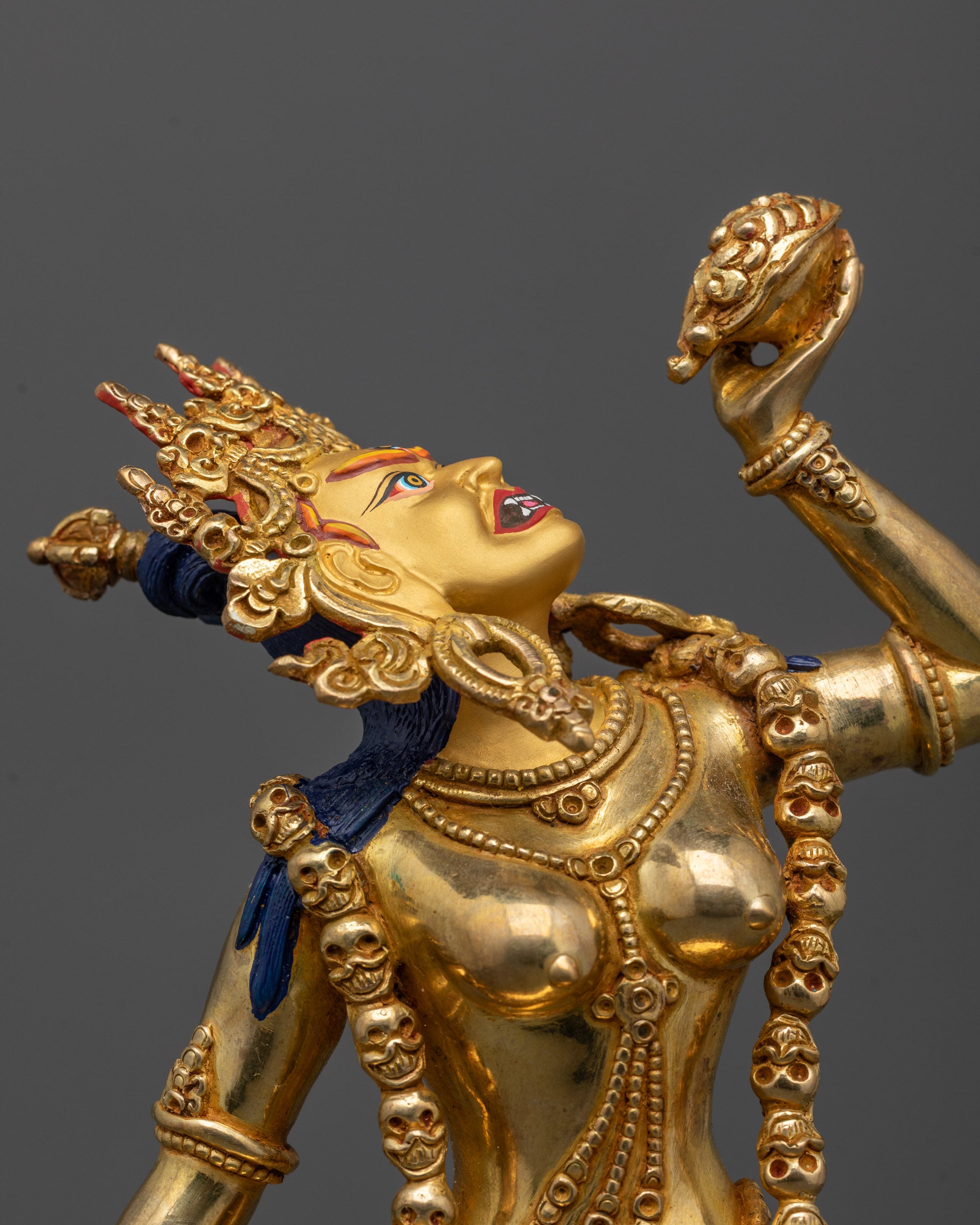 close up of Vajrayogini statue’s gold-gilded face and delicate robes showing intricate details