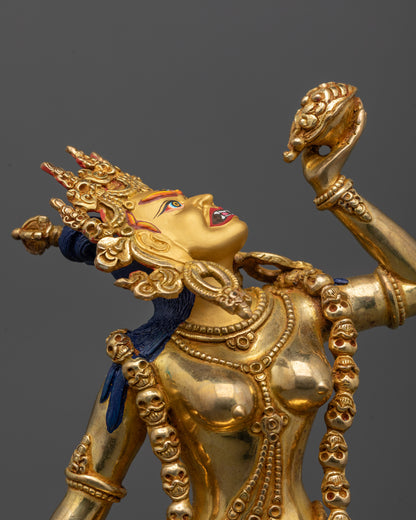 close up of Vajrayogini statue’s gold-gilded face and delicate robes showing intricate details