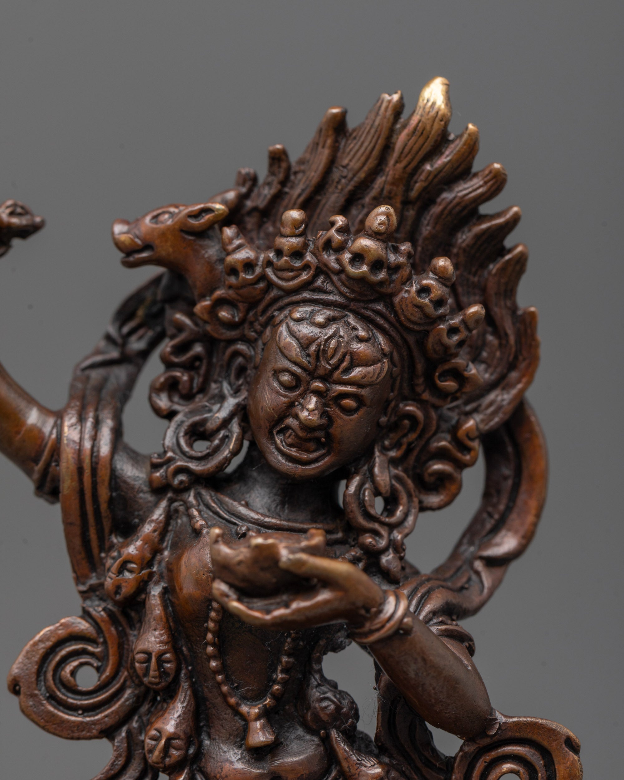 close up of dorje phagmo statue showing oxidized copper face and radiant halo details