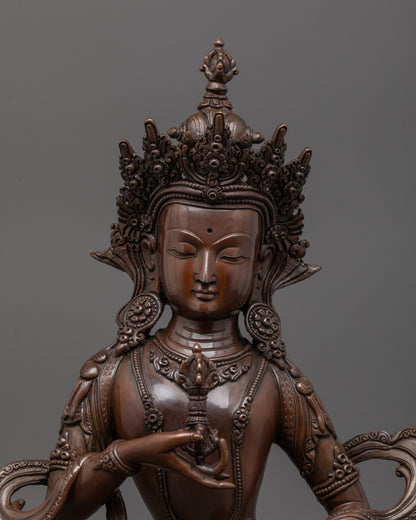 close up of dorje sempa face and vajra bell details in oxidized copper sculpture