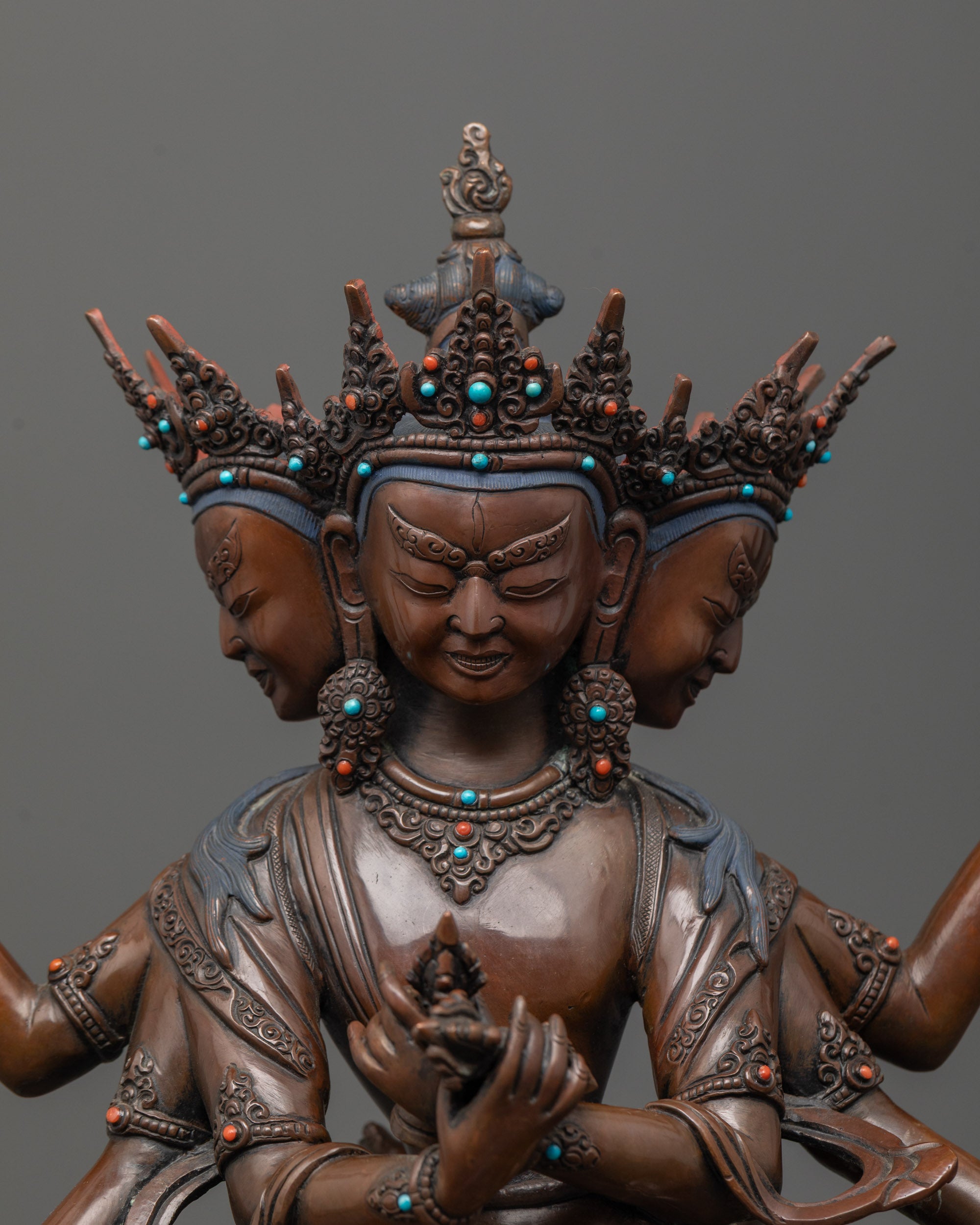 close up of guhysamaja union statue adorned with semi precious stones and earthly hue