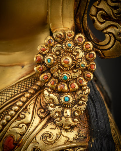 close up of guru earrings left Padmasambhava statue gold gilded detail handmade Nepal