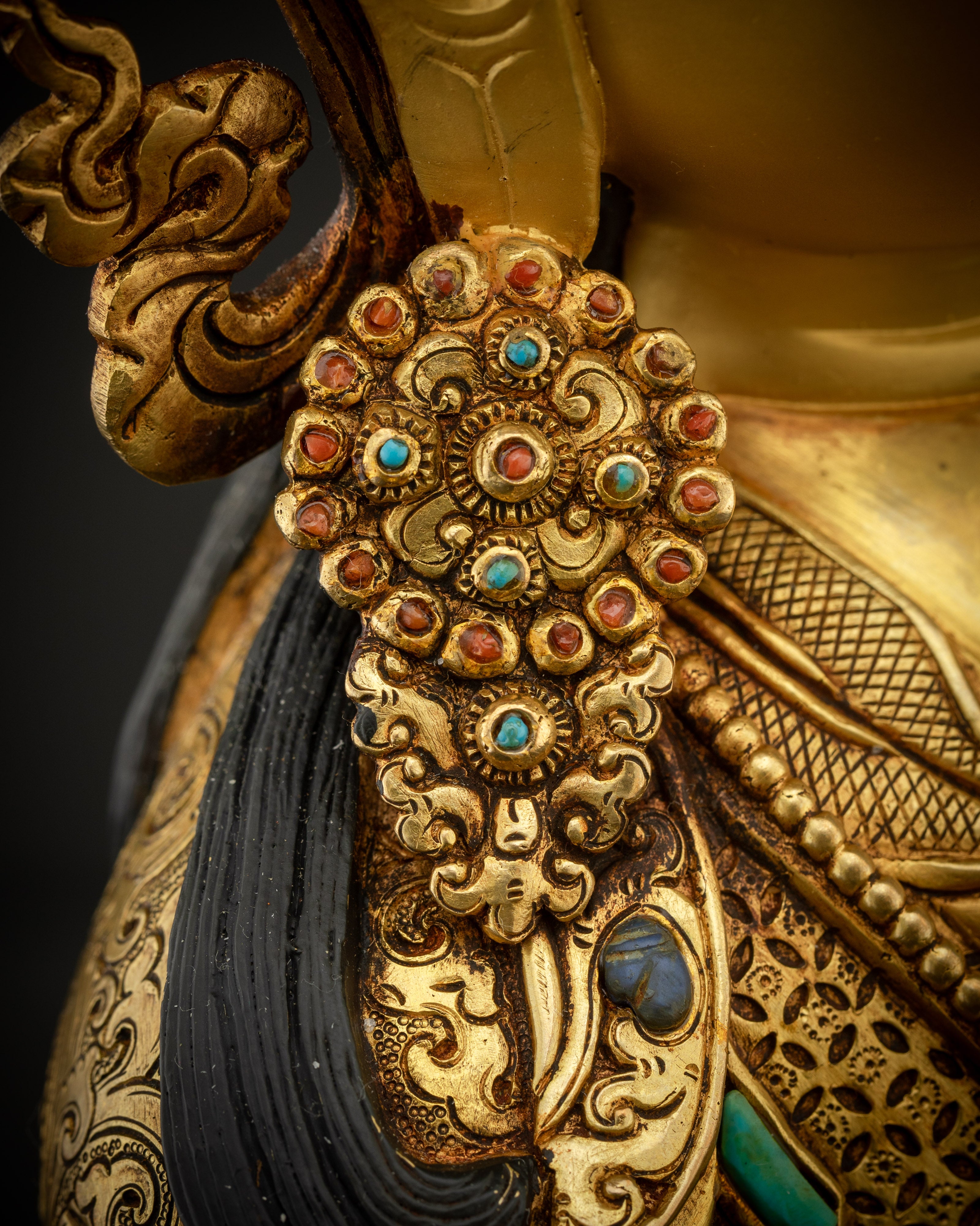close up of guru earrings right Padmasambhava statue gold gilded detail handmade Nepal
