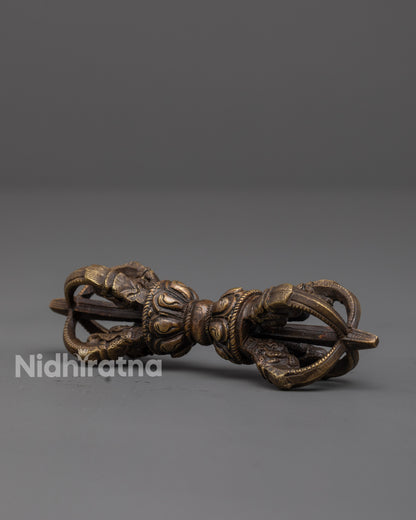 close up of handcrafted bronze vajra with intricate patterns for tibetan rituals