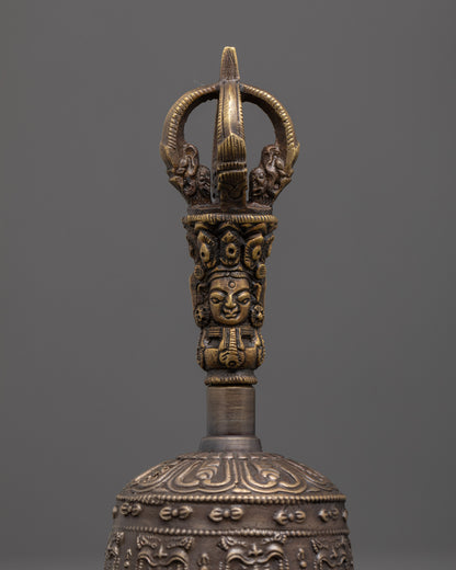 close up of intricate bronze bell carvings with brass handle deity details