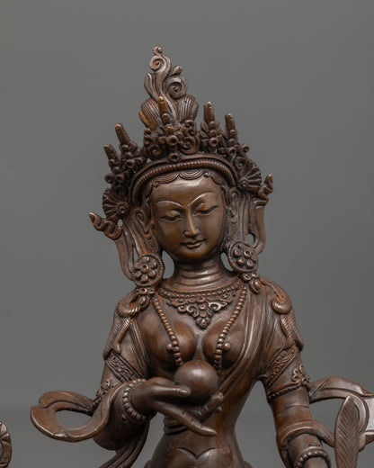 close up of ksitigarbha statue crown and chintamani in oxidized copper finish