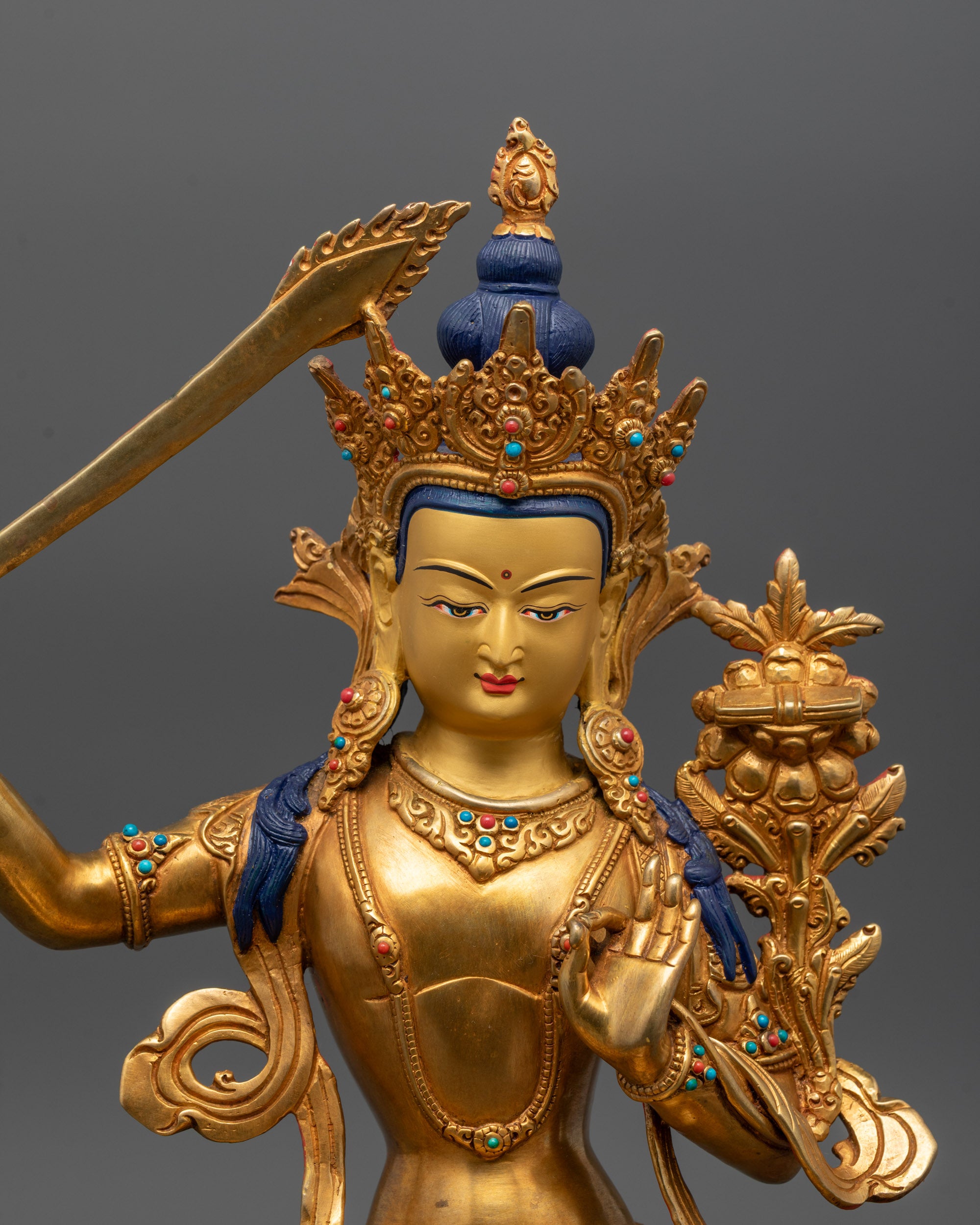 close up of manjushri statue crown robe and semi-precious stone details in fine craftsmanship