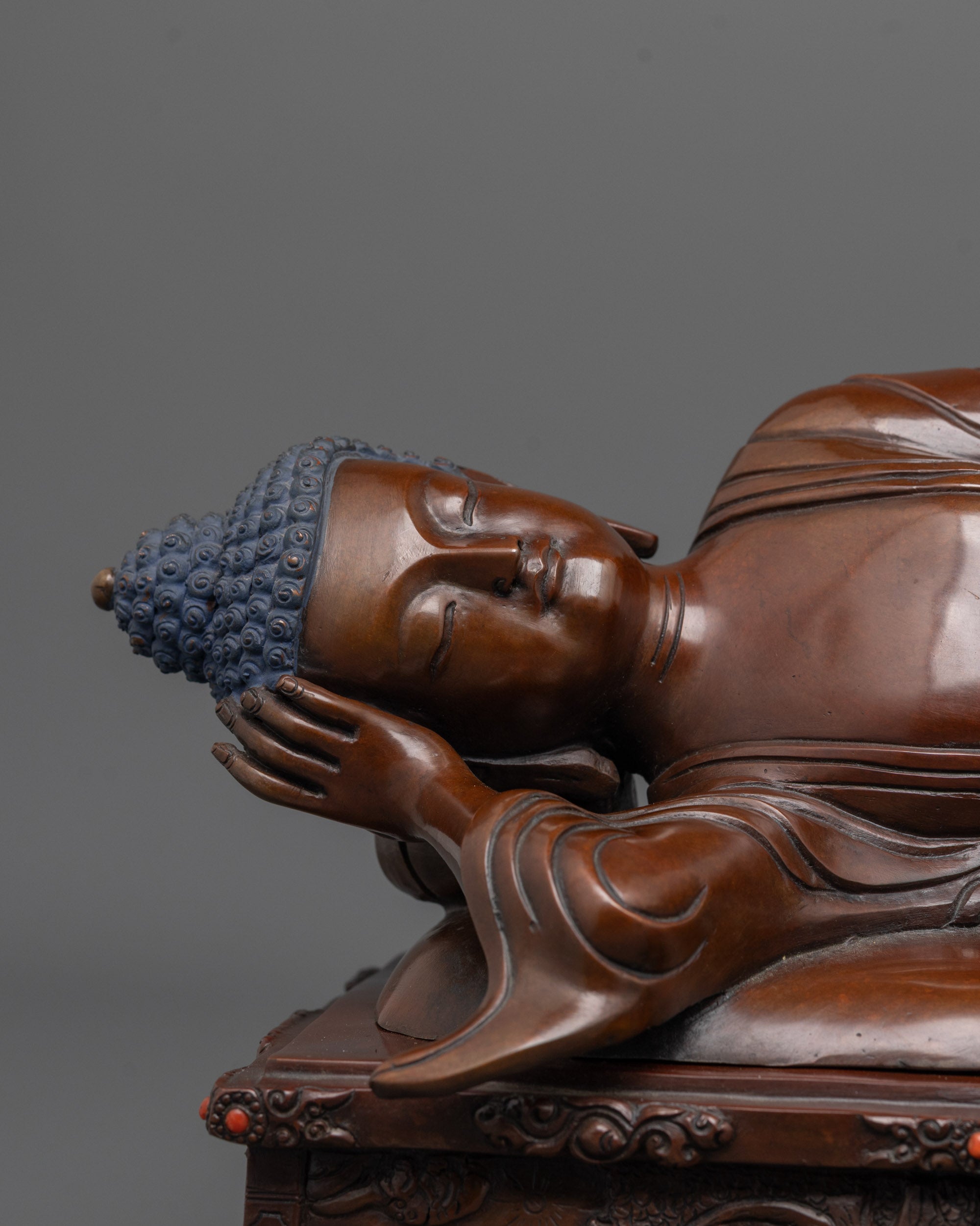 close up of nirvana buddha face with oxidized copper texture and peaceful expression