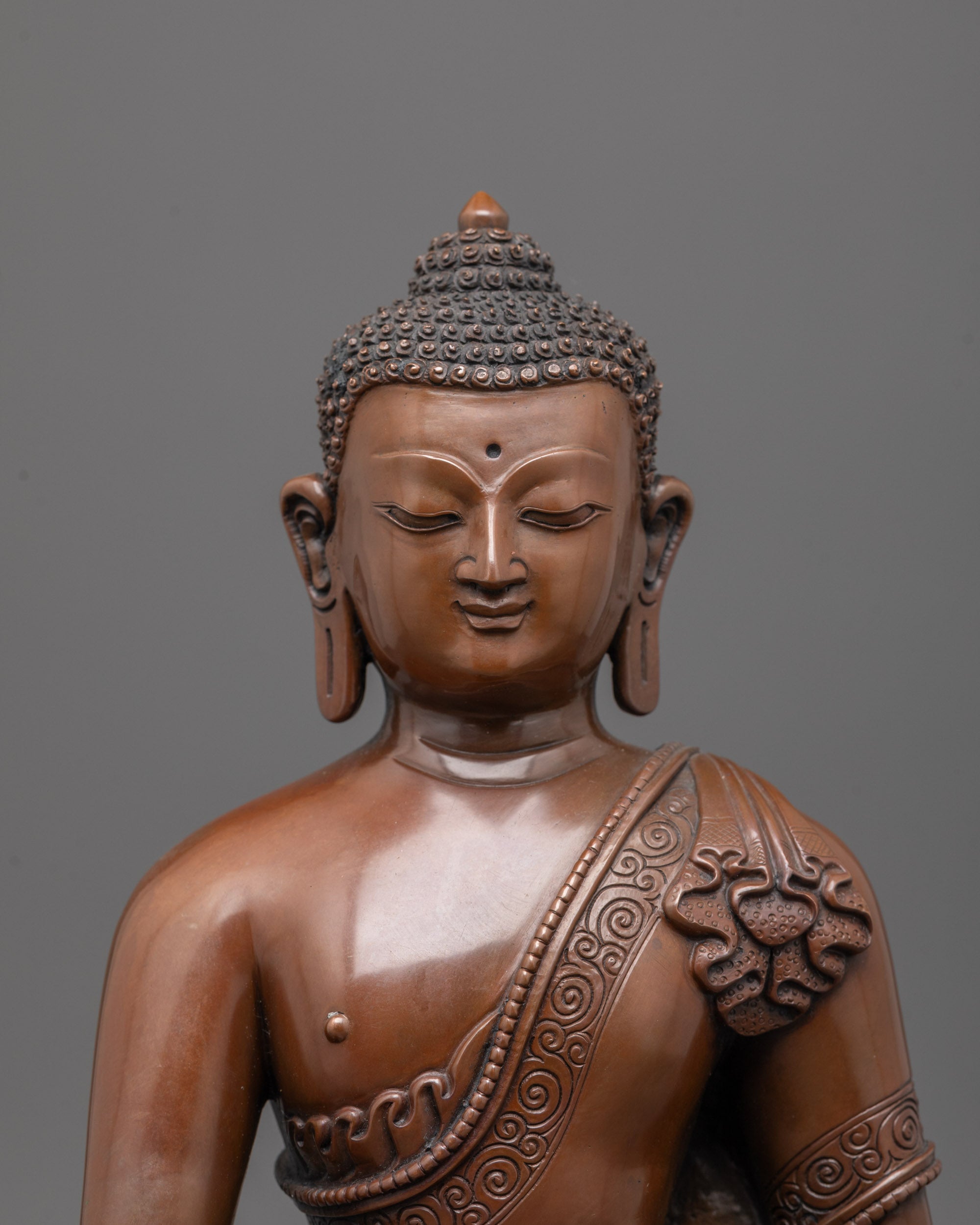 close up of oxidized copper face showing serene expression of Gautama Buddha statue