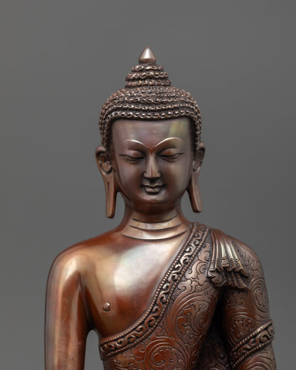 close up of oxidized copper shakyamuni buddha statue with carved patterns and patra bowl