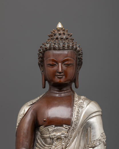 close up of patra bowl and earth-touching mudra on oxidized buddha statue
