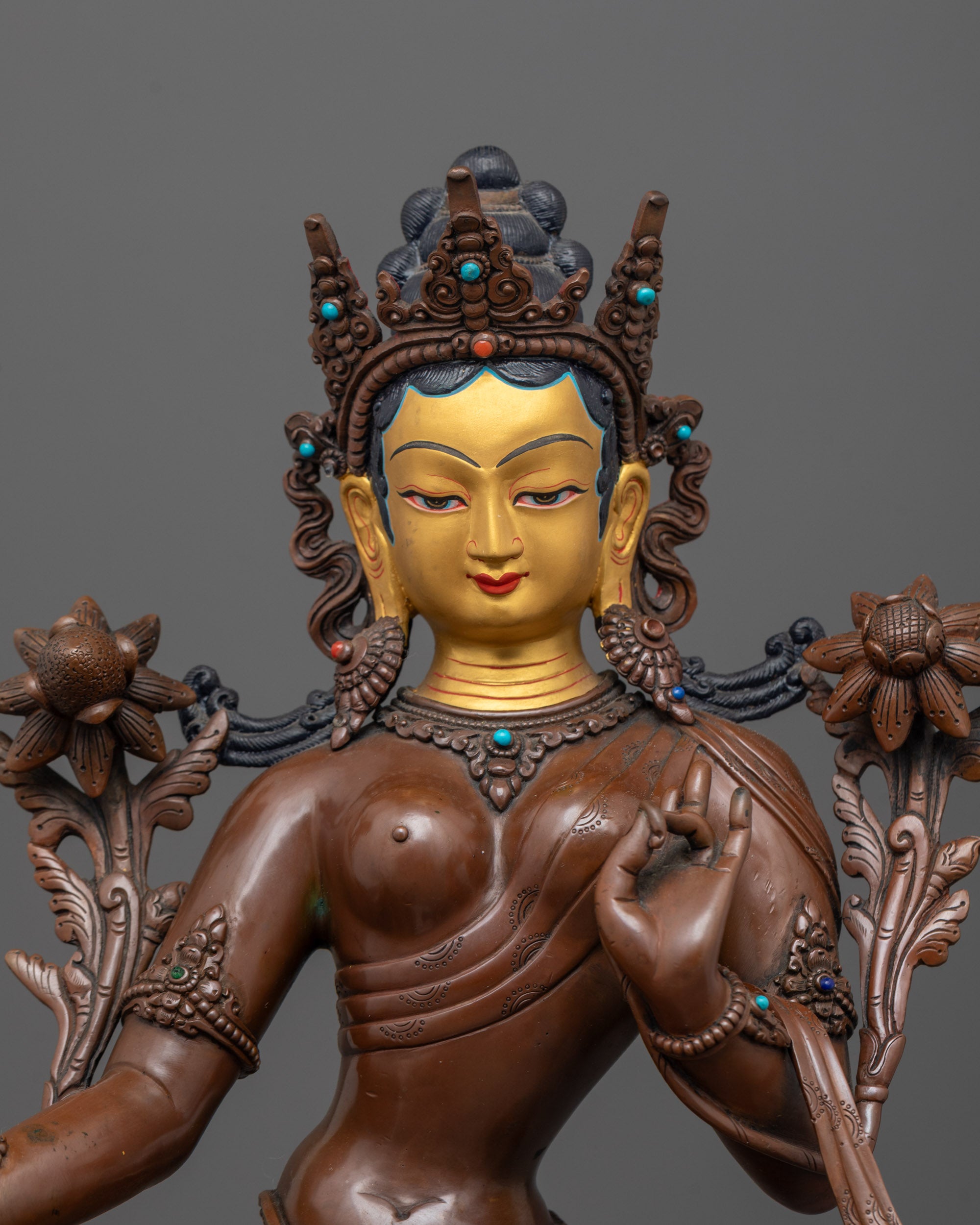close up of tara devi’s gold-gilded face with carved crown and semi-precious stone inlays