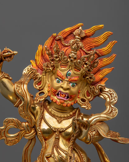 close up of vajrapani statue showing serpent necklace and vajra in hand