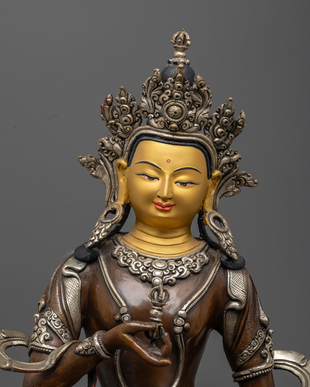 close up of vajrasattva statue crown and jewelry with silver-plated intricate designs