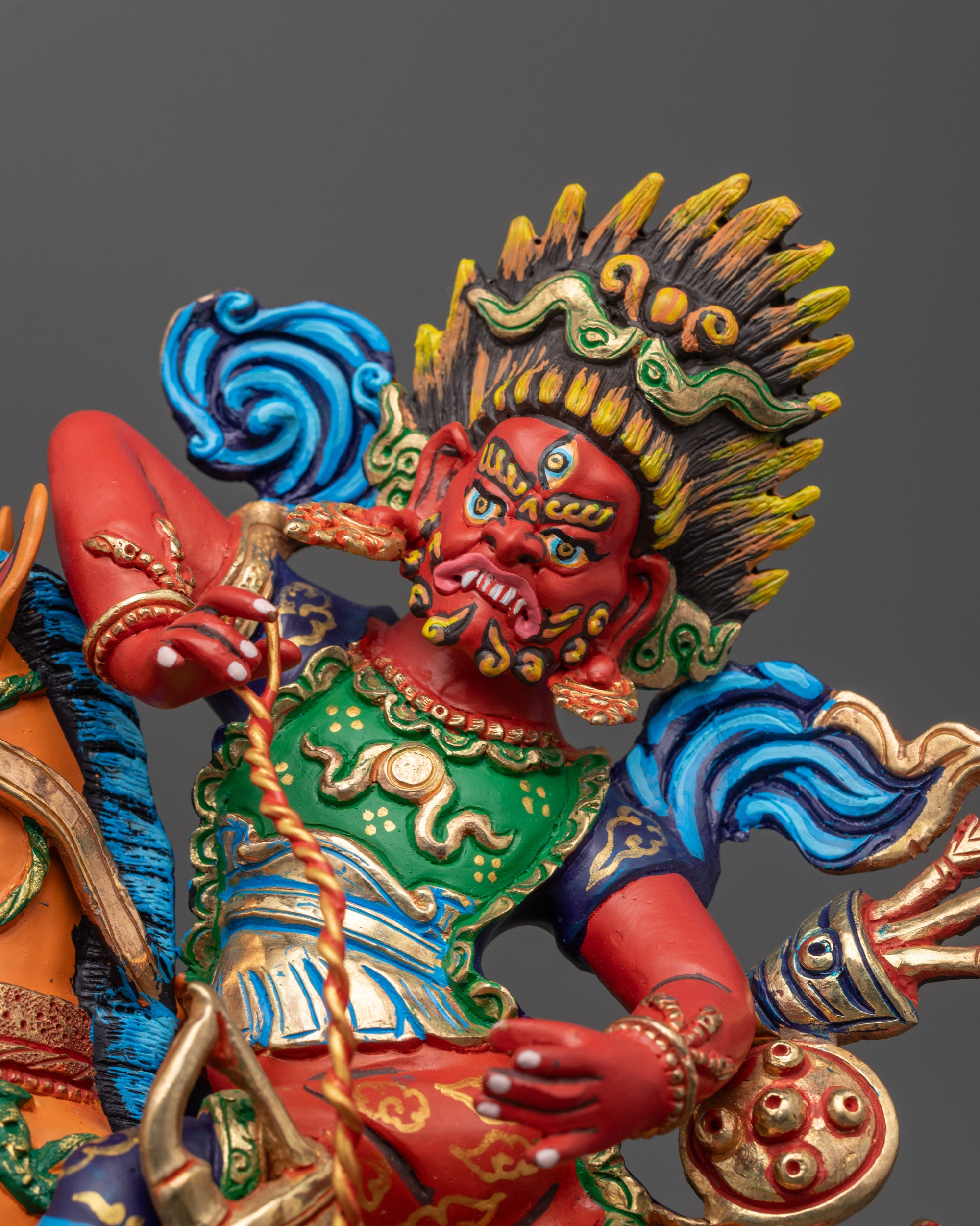 close up red-hued Tsengo Rolpa Chudan face with wrathful expression and staff
