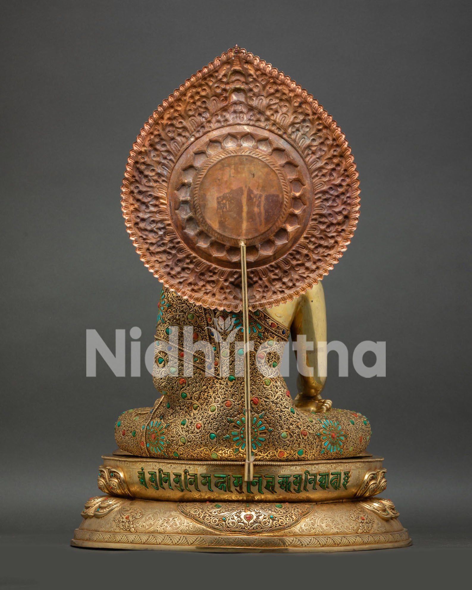 copper reverse of Buddha statue's halo with mantra inscribed at the base