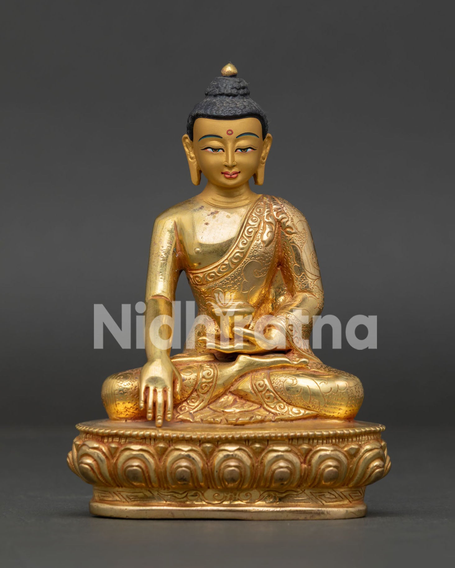 Copper Shakyamuni Buddha statue with lotus pedestal and hand-carved monk robe details.