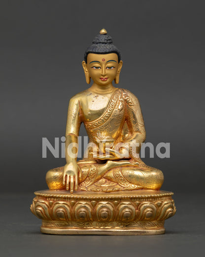 Copper Shakyamuni Buddha statue with lotus pedestal and hand-carved monk robe details.