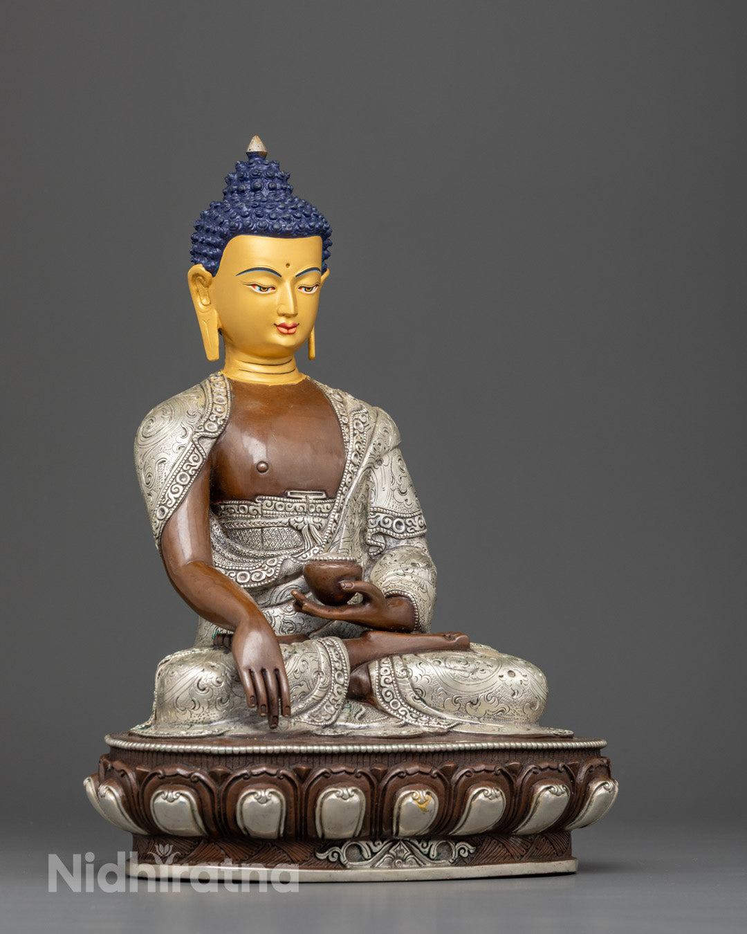 Copper Shakyamuni Buddha statue with oxidized silver-plated finish and floral robe