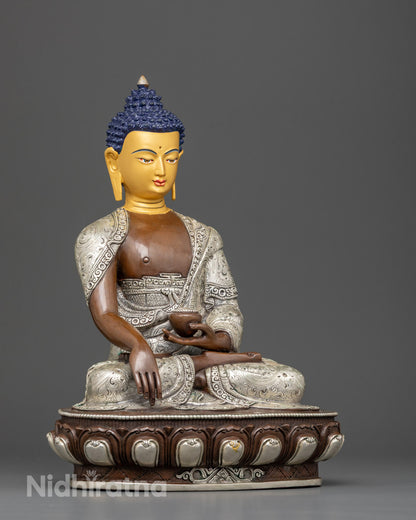 Copper Shakyamuni Buddha statue with oxidized silver-plated finish and floral robe