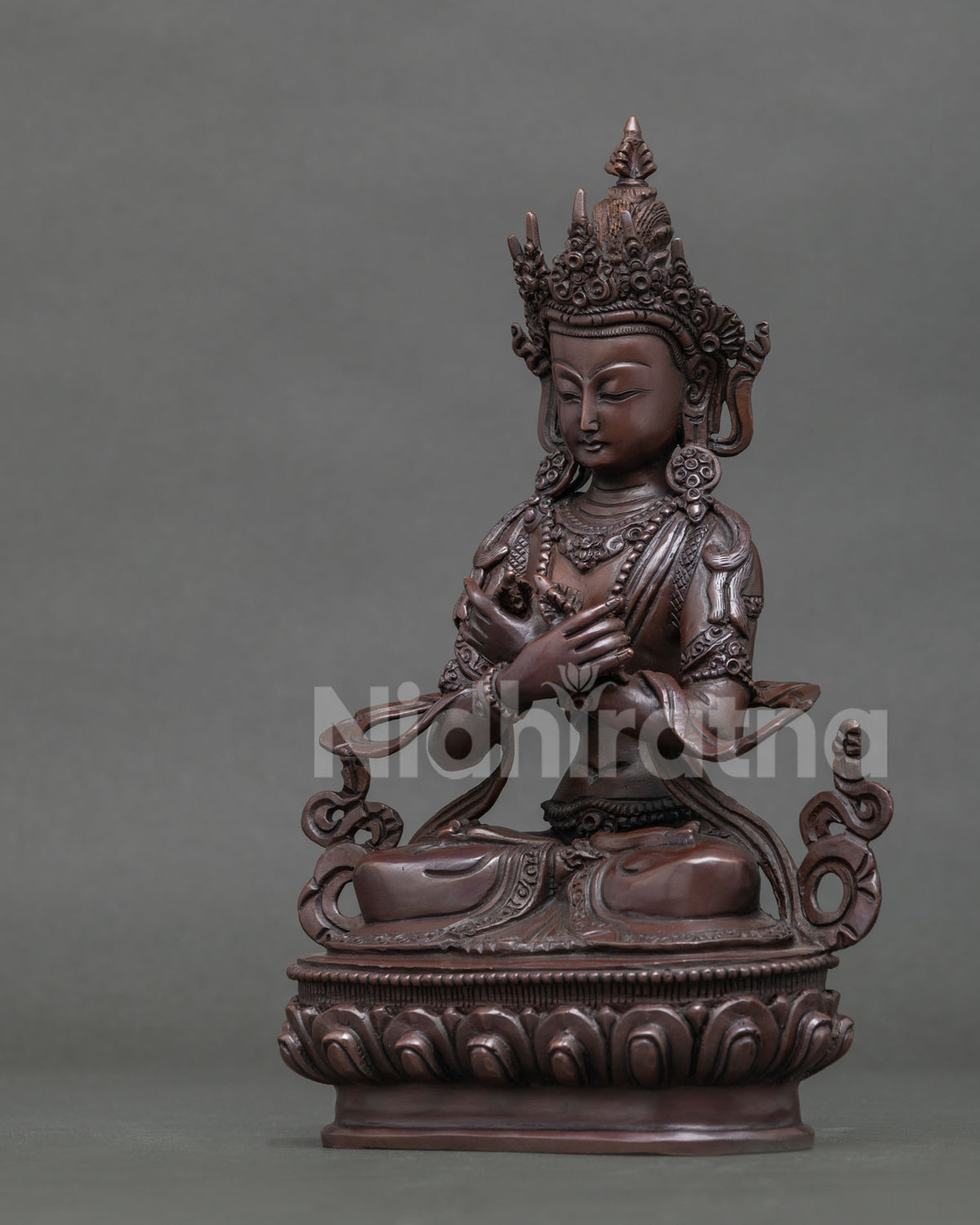 Copper Vajradhara statue holding vajra in right hand and bell in left hand.