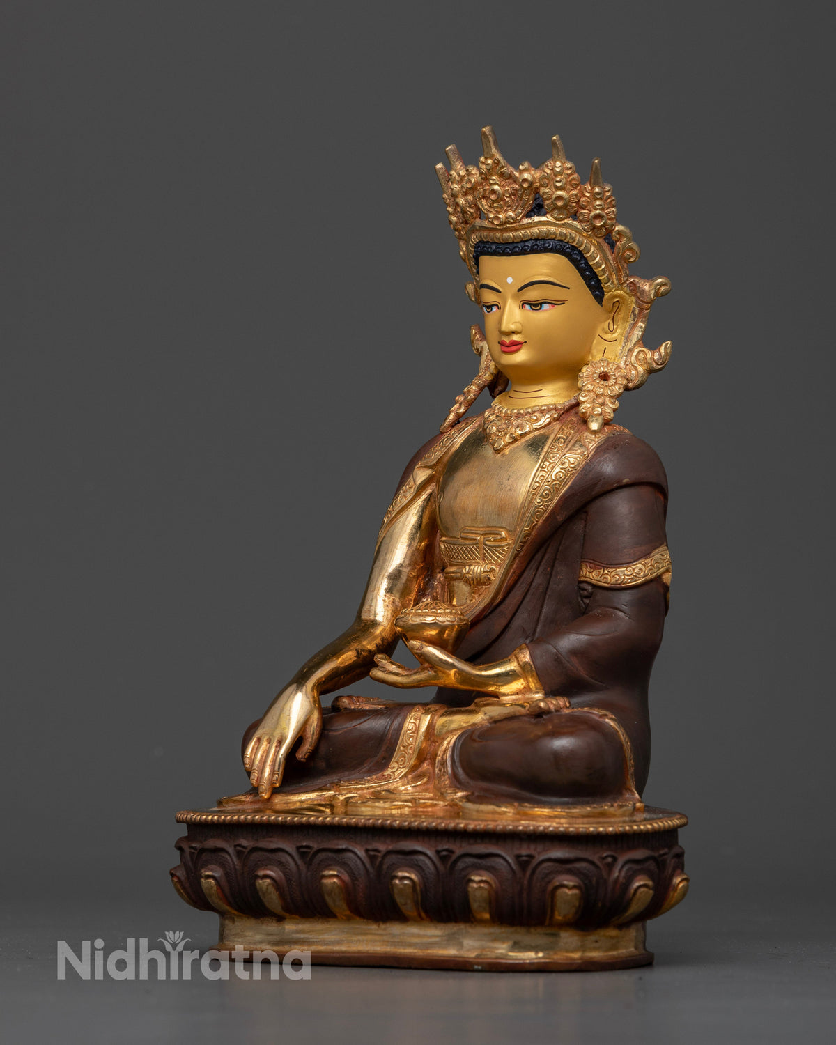 Crowned Shakyamuni Buddha statue showing Bhumisparsha Mudra and begging bowl.
