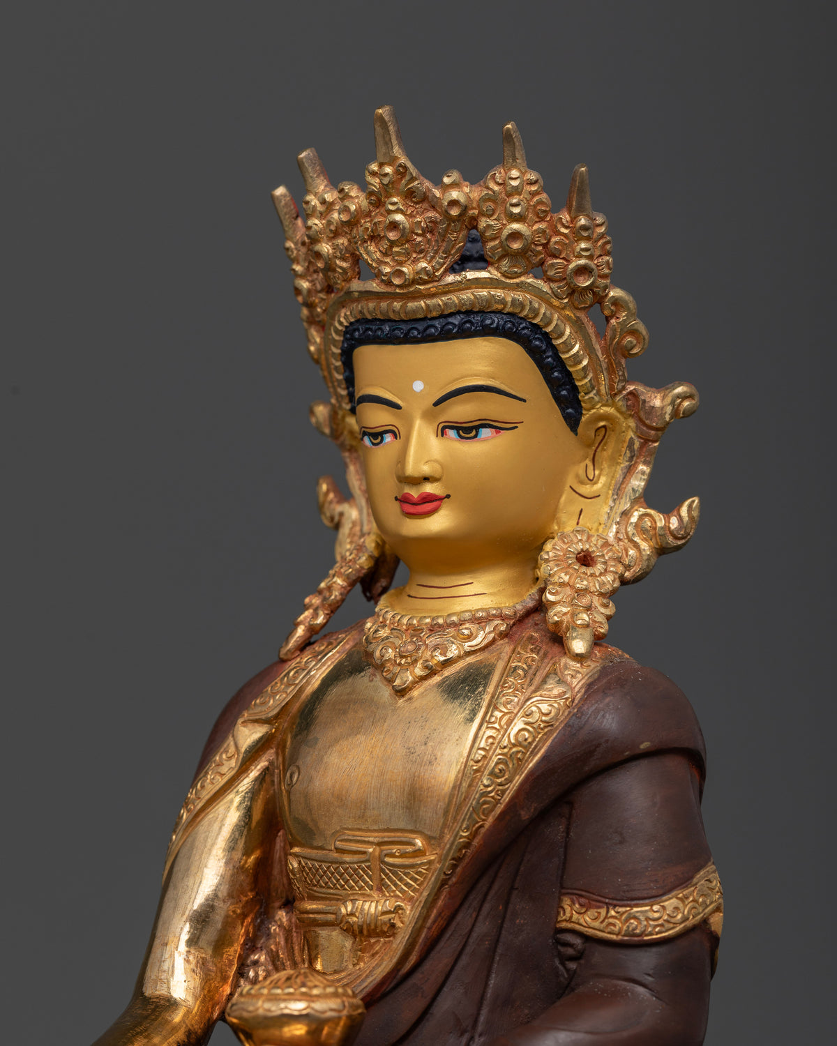 Crowned Shakyamuni Buddha statue with detailed crown and serene expression.