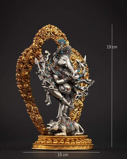 Dancing Ganesha statue standing on Mushika with twelve arms holding sacred implements