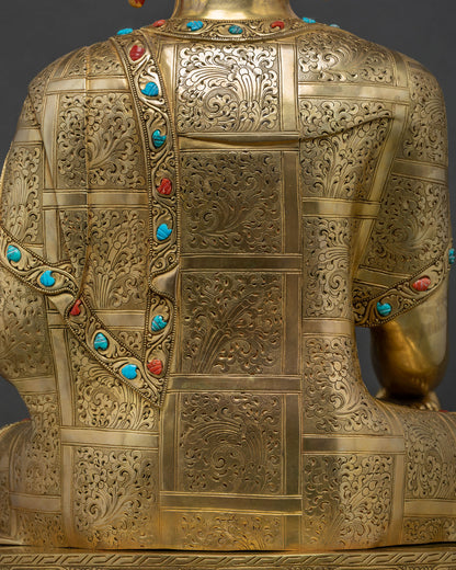 Detail of hand-chased floral filigree on Buddha statue's back robe