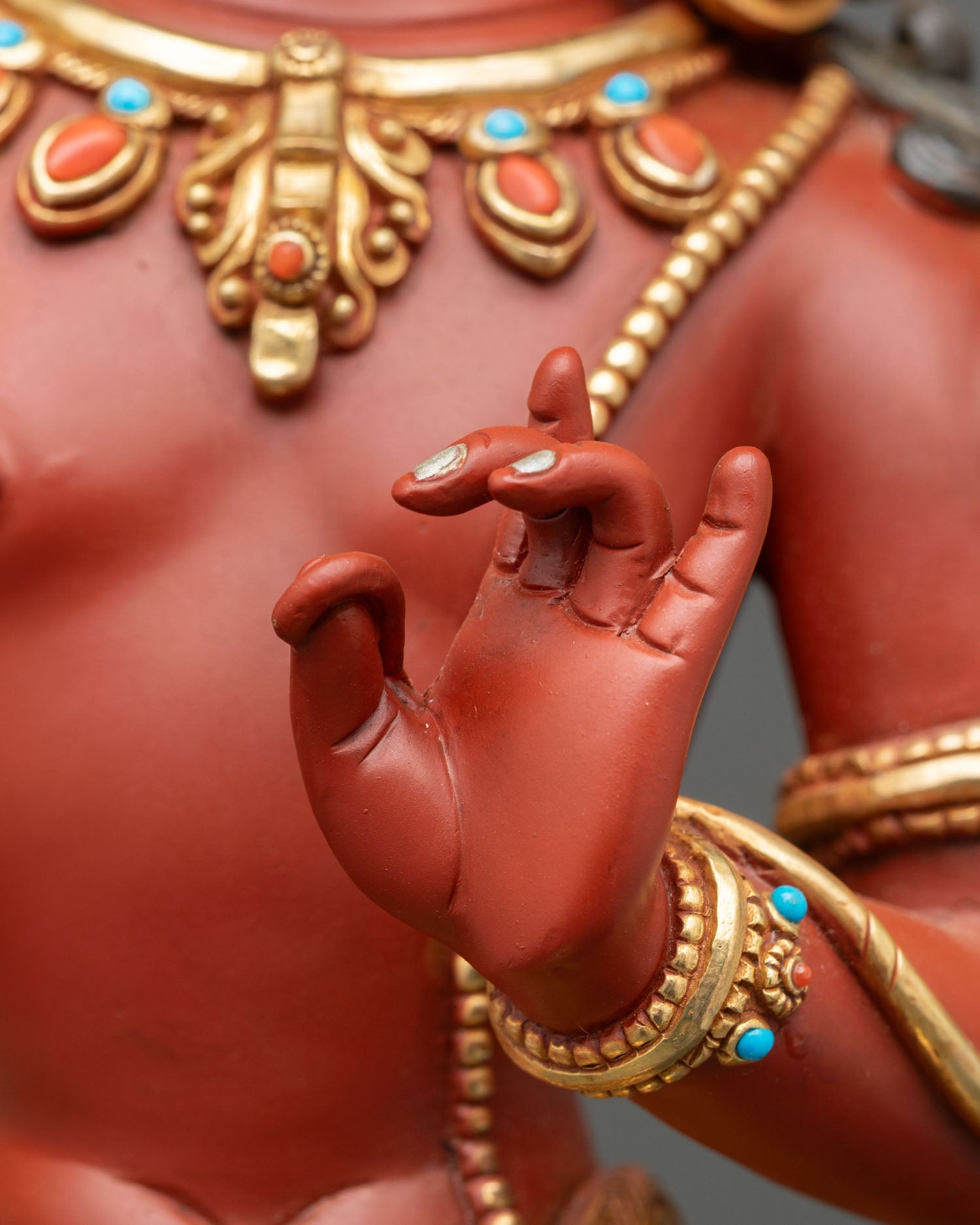 Detail of Maha Manjushri hand mudra, red acrylic finish on copper