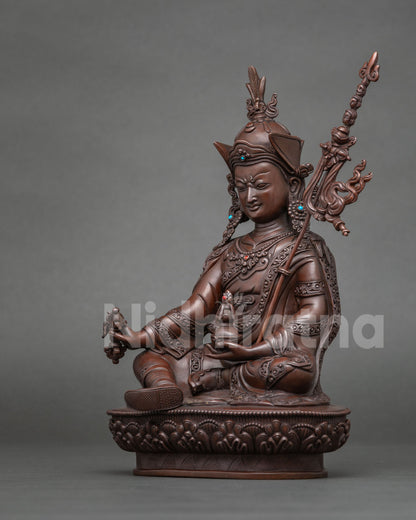 Detail of skull cup in lap of Guru Rinpoche copper statue on lotus base
