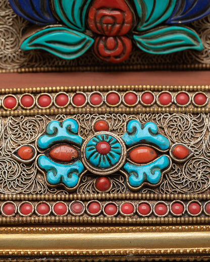 Detail view of lower mandala showing Vajra symbol finely designed in copper gold plated artwork representing strength wisdom and spiritual power